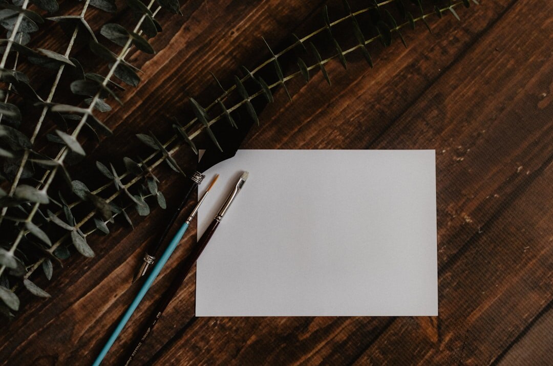 Handwritten manuscript pages with pen edits on a wooden table