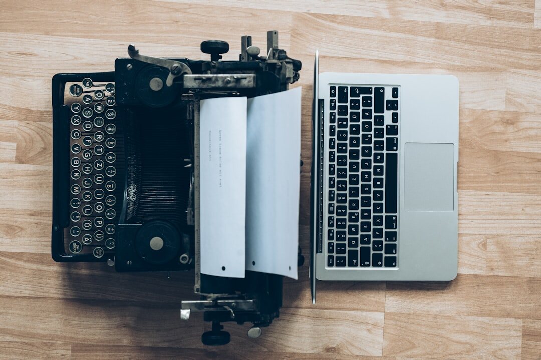 Vintage typewriter on a wooden desk with a notebook and coffee cup